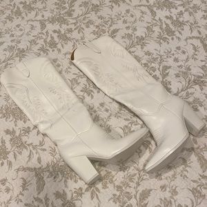 Tall white cowboy boots.